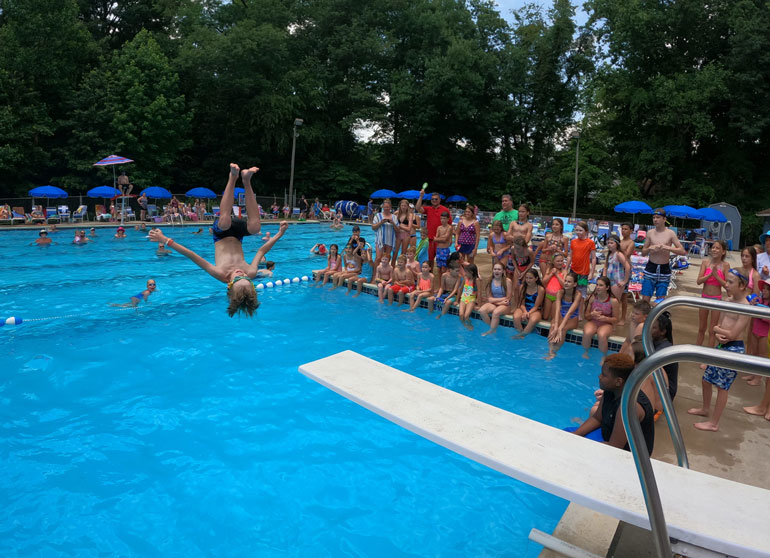 DivingBoard Child flipping off of a diving board at Fair Blue Swim Club