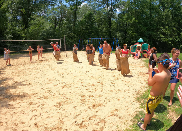 Sandpit Children participating in a sack race in a sand pit at Fair Blue Swim Club